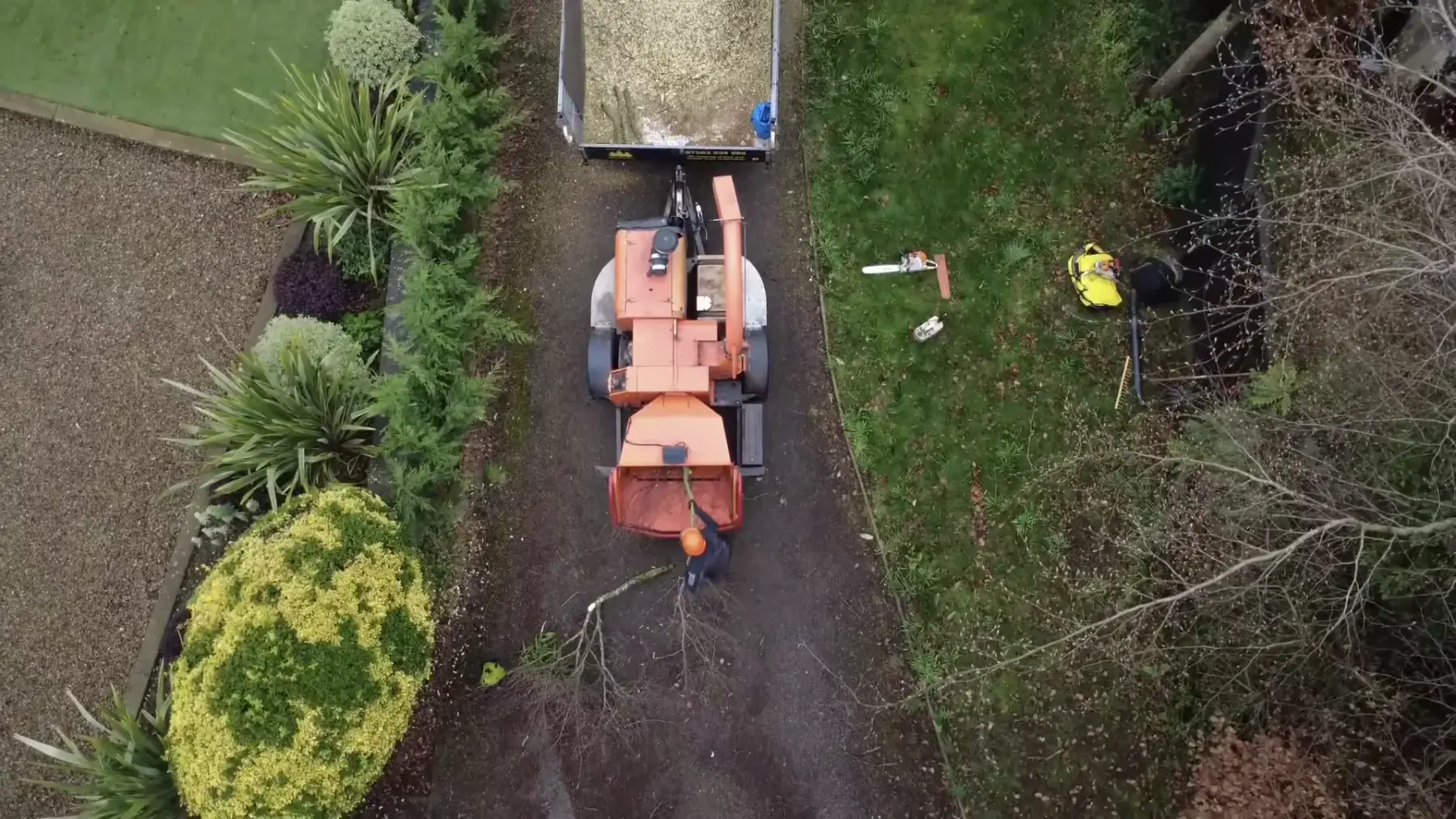 Narrow-access stump grinder removing a tree stump in a garden, viewed from above